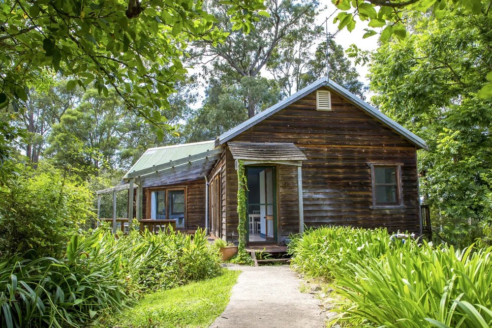 The Cottage nestled in lush gardens